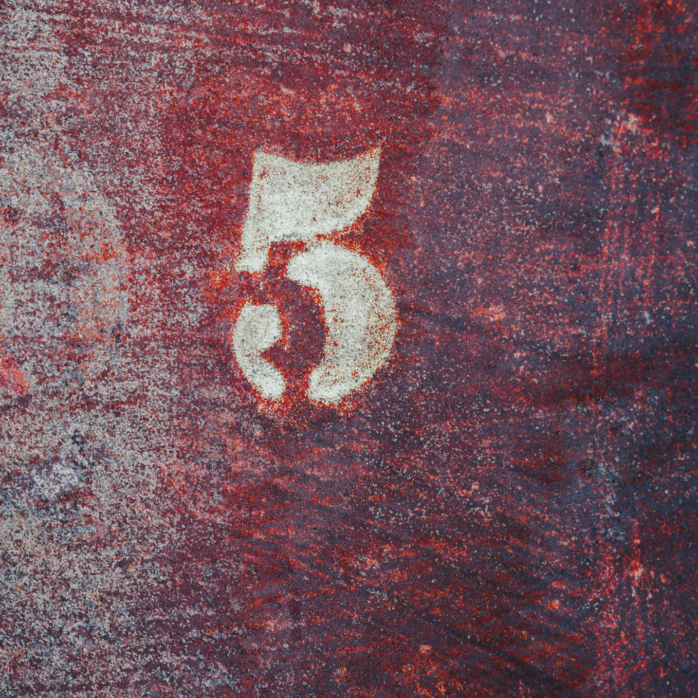 A large white stenciled number five on a weathered red and blue textured surface, representing the five strategies covered in this article